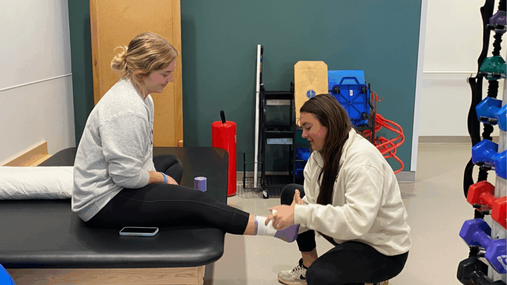 athletic trainer wrapping ankle