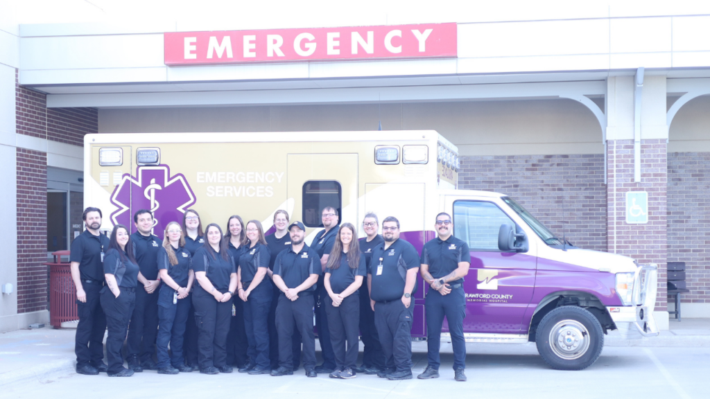 EMTs and Paramedics at CCMH in front of ambulance