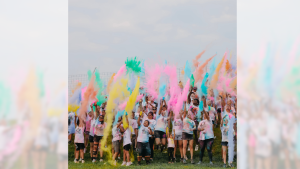 runners throwing color after CCMH Color Run