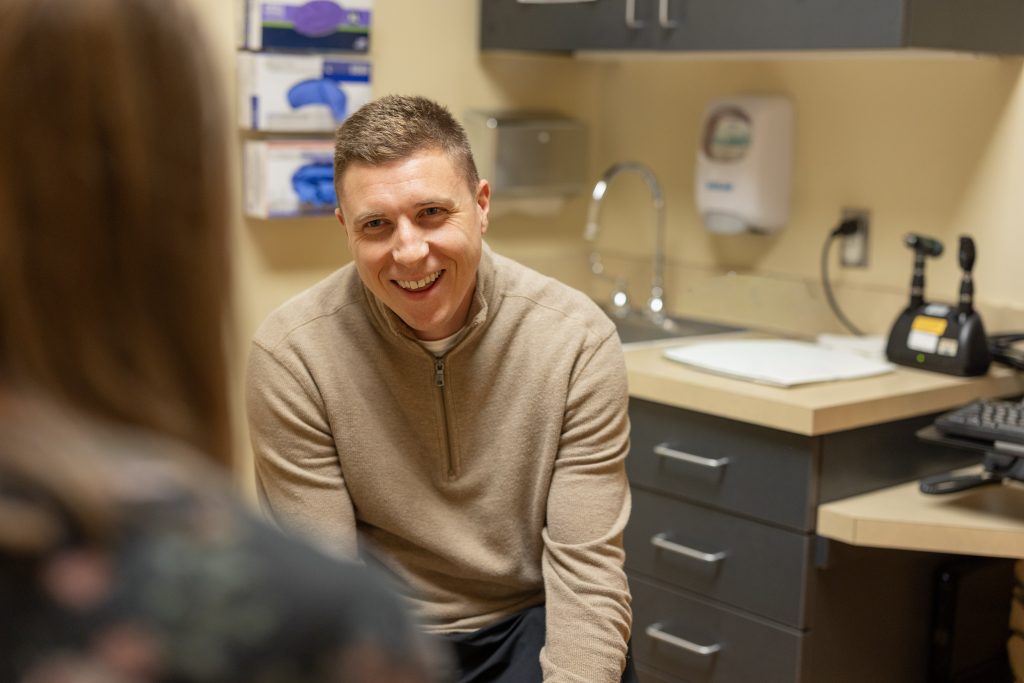 Dr. Rathe helping patient during appointment at Crawford County Memorial Hospital