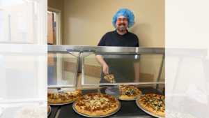 Svenn from dietary service serving pizza in the cafe at CCMH
